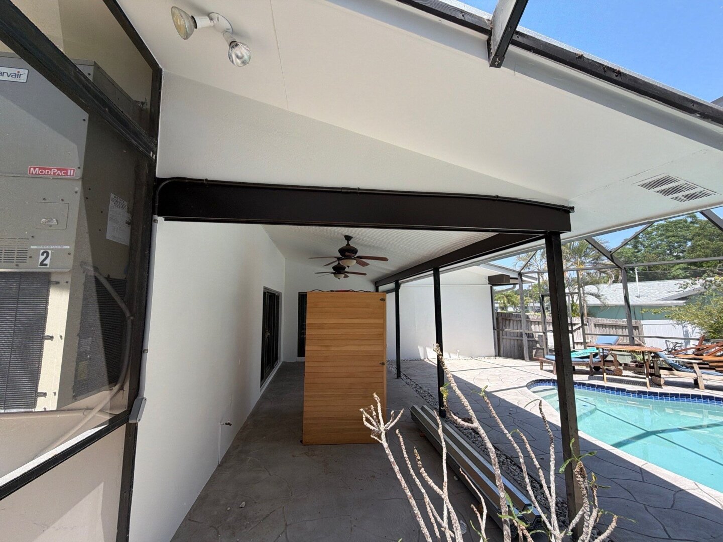 Dunedin home covered pool patio with refinished tongue-and-groove ceiling