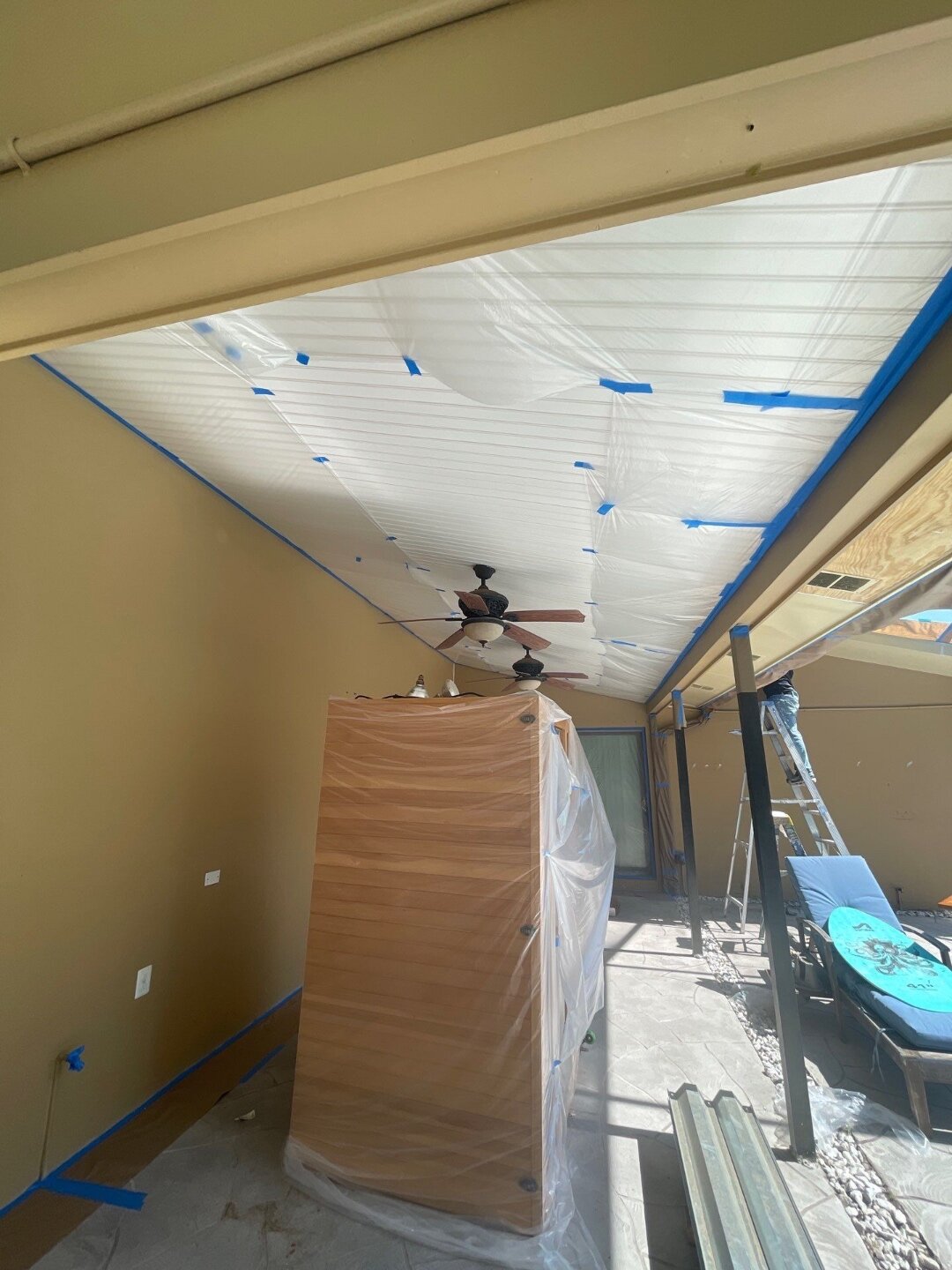Highmark prep work in progress with patio ceiling masked in protective plastic before exterior painting